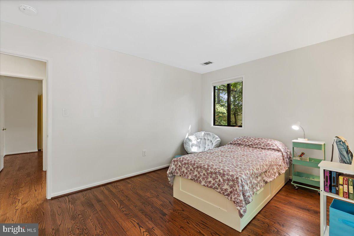 9411 Fernwood Road Bethesda, MD 20817 - Photo 46 of 101 a bedroom with a bed and wooden floor