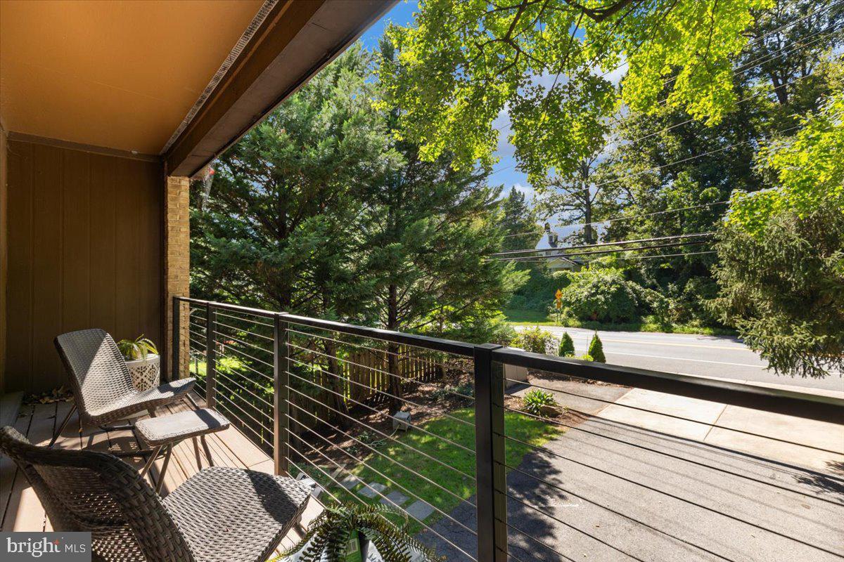 9411 Fernwood Road Bethesda, MD 20817 - Photo 48 of 101 a view of a balcony with wooden floor and outdoor seating