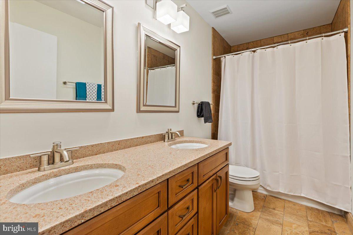 9411 Fernwood Road Bethesda, MD 20817 - Photo 51 of 101 a bathroom with a granite countertop sink and a mirror
