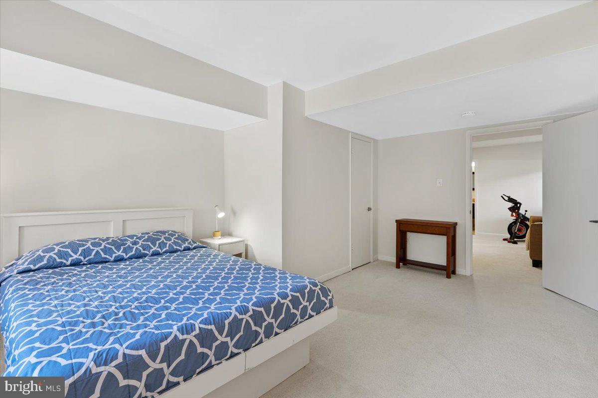 9411 Fernwood Road Bethesda, MD 20817 - Photo 63 of 101 a bedroom with a bed and a chair