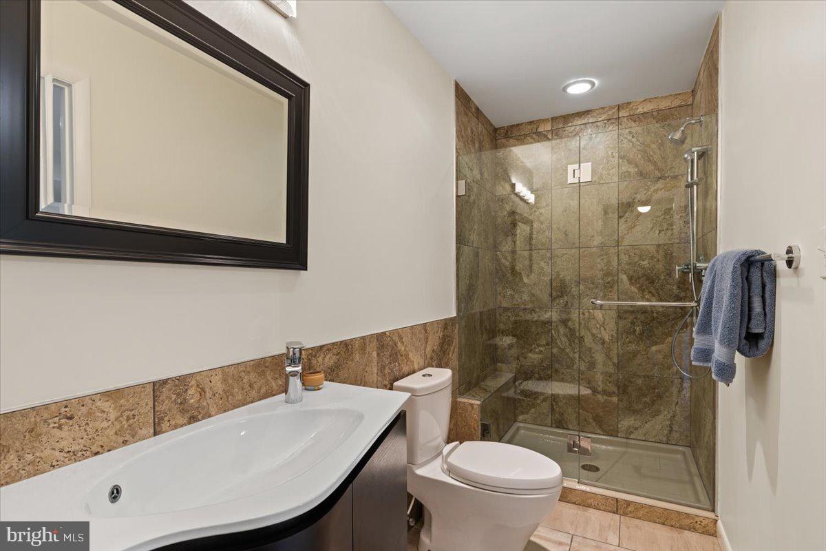 9411 Fernwood Road Bethesda, MD 20817 - Photo 65 of 101 a bathroom with a sink a toilet and shower