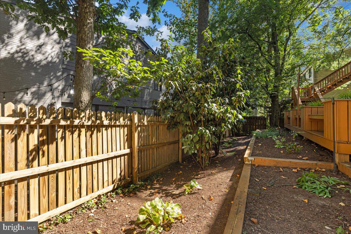 9411 Fernwood Road Bethesda, MD 20817 - Photo 81 of 101 a view of a pathway of a house with wooden fence