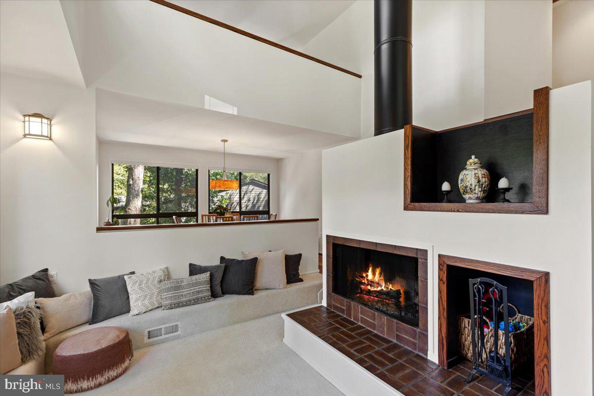 9411 Fernwood Road Bethesda, MD 20817 - Photo 10 of 101 a living room with furniture a fireplace and a flat screen tv