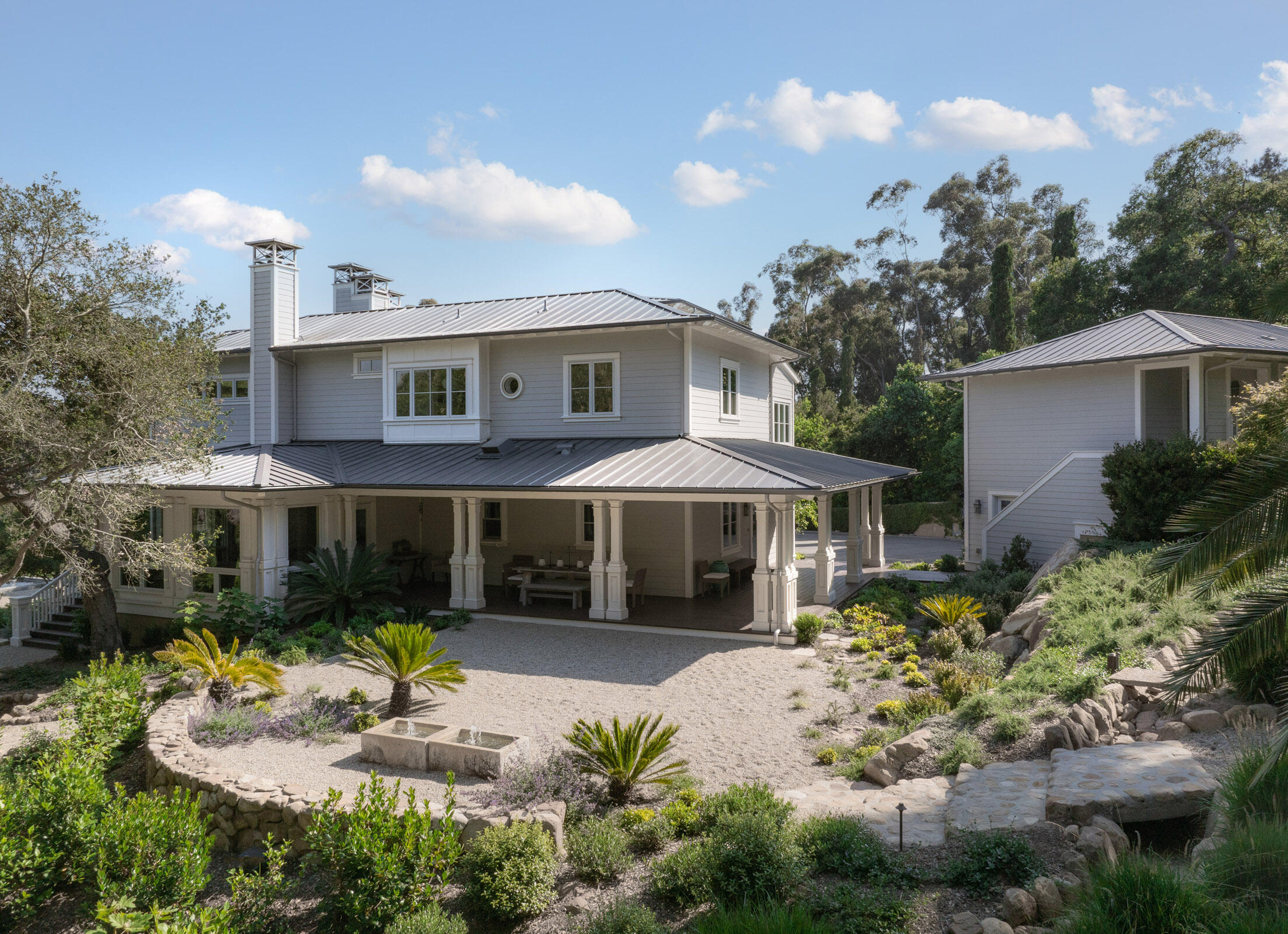 Undisclosed Address Montecito, CA 93108 - Photo 30 of 41 a front view of a house with a yard and a garden