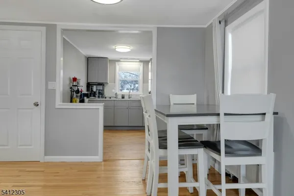 a kitchen with a sink cabinets and wooden floor