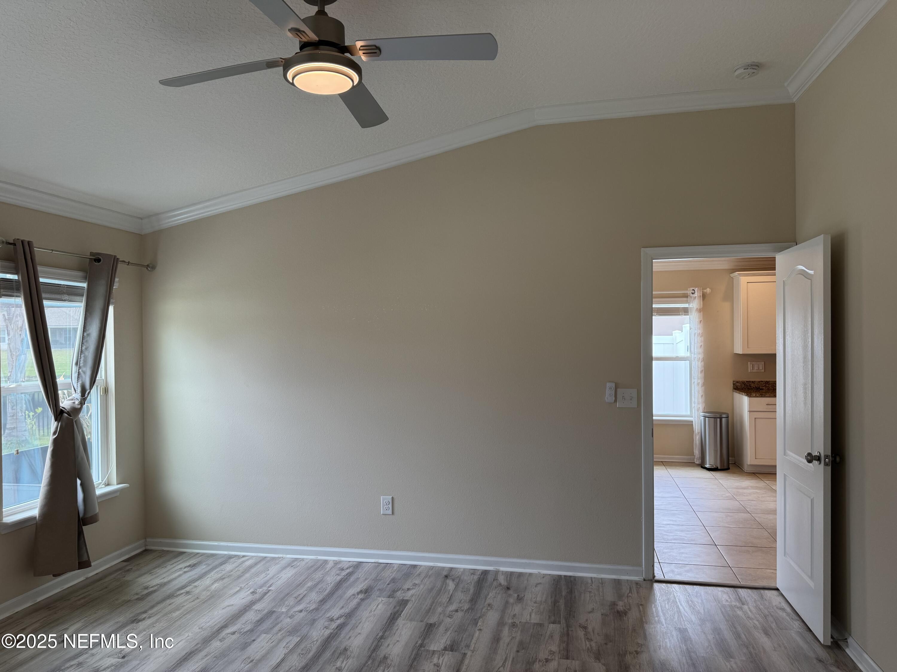 96 Midway Park Drive St. Augustine, FL 32084 - Photo 12 of 31 wooden floor in an empty room with a window