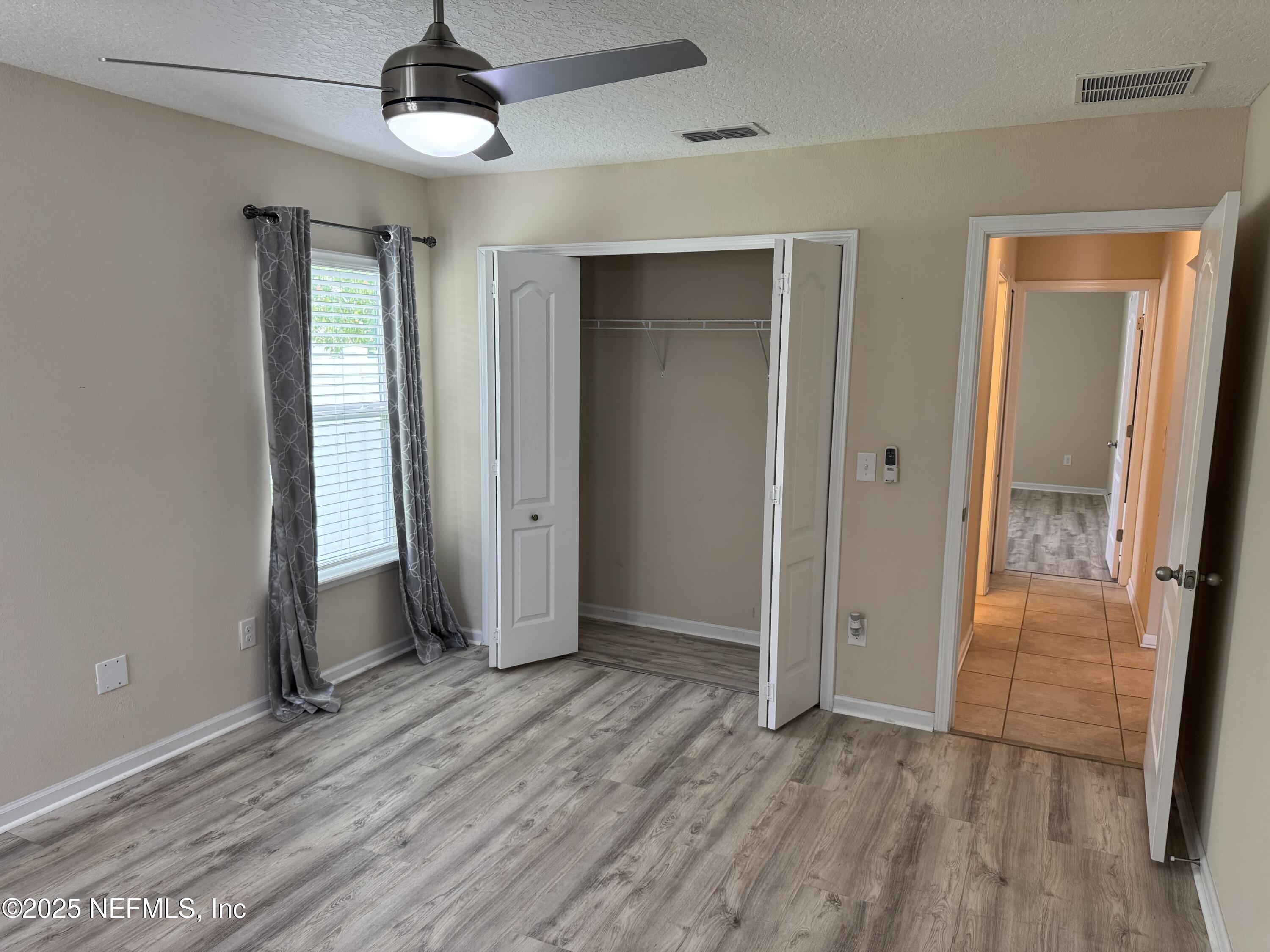 96 Midway Park Drive St. Augustine, FL 32084 - Photo 18 of 31 wooden floor in an empty room with a window