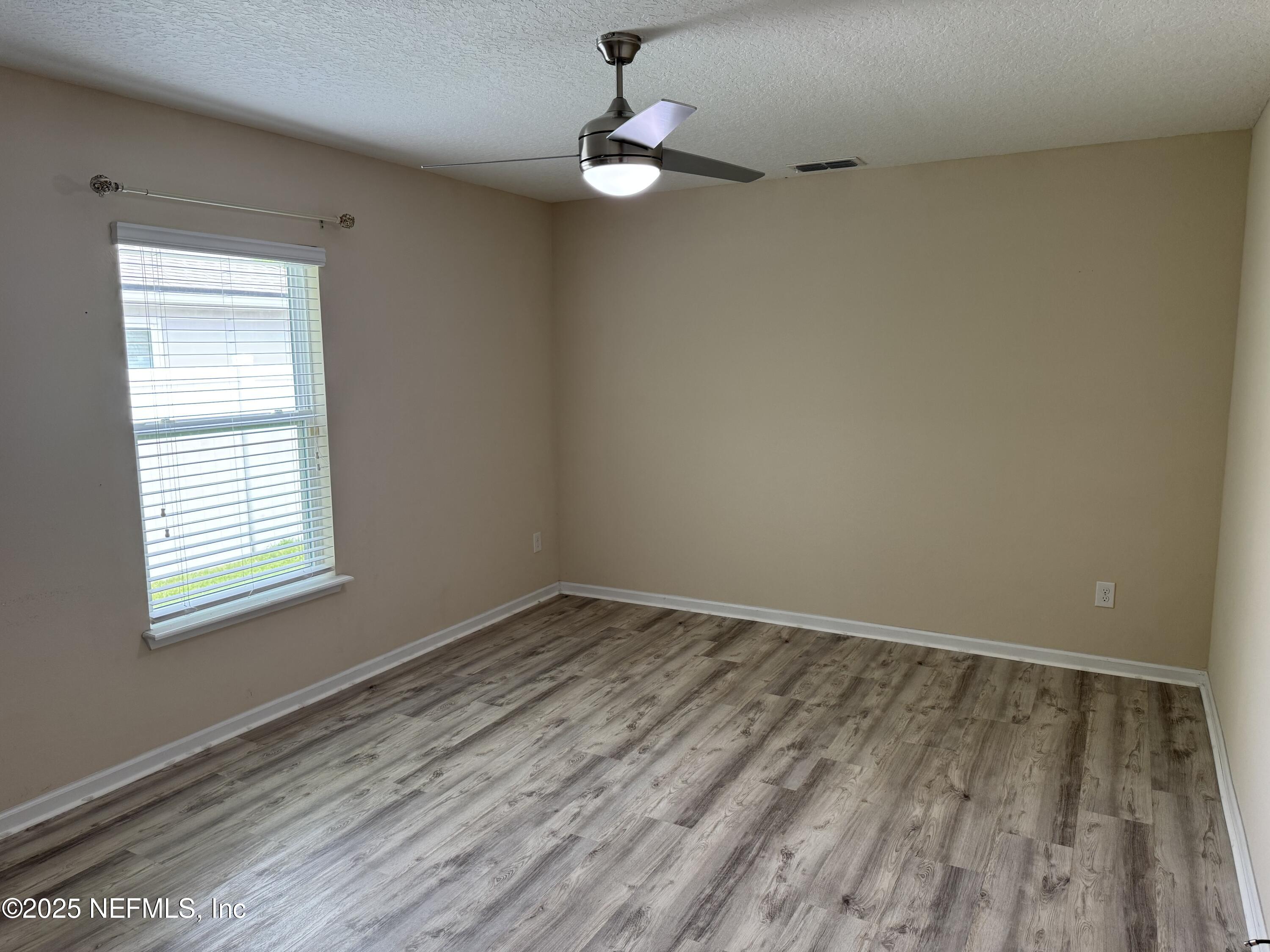 96 Midway Park Drive St. Augustine, FL 32084 - Photo 20 of 31 wooden floor in an empty room with a window