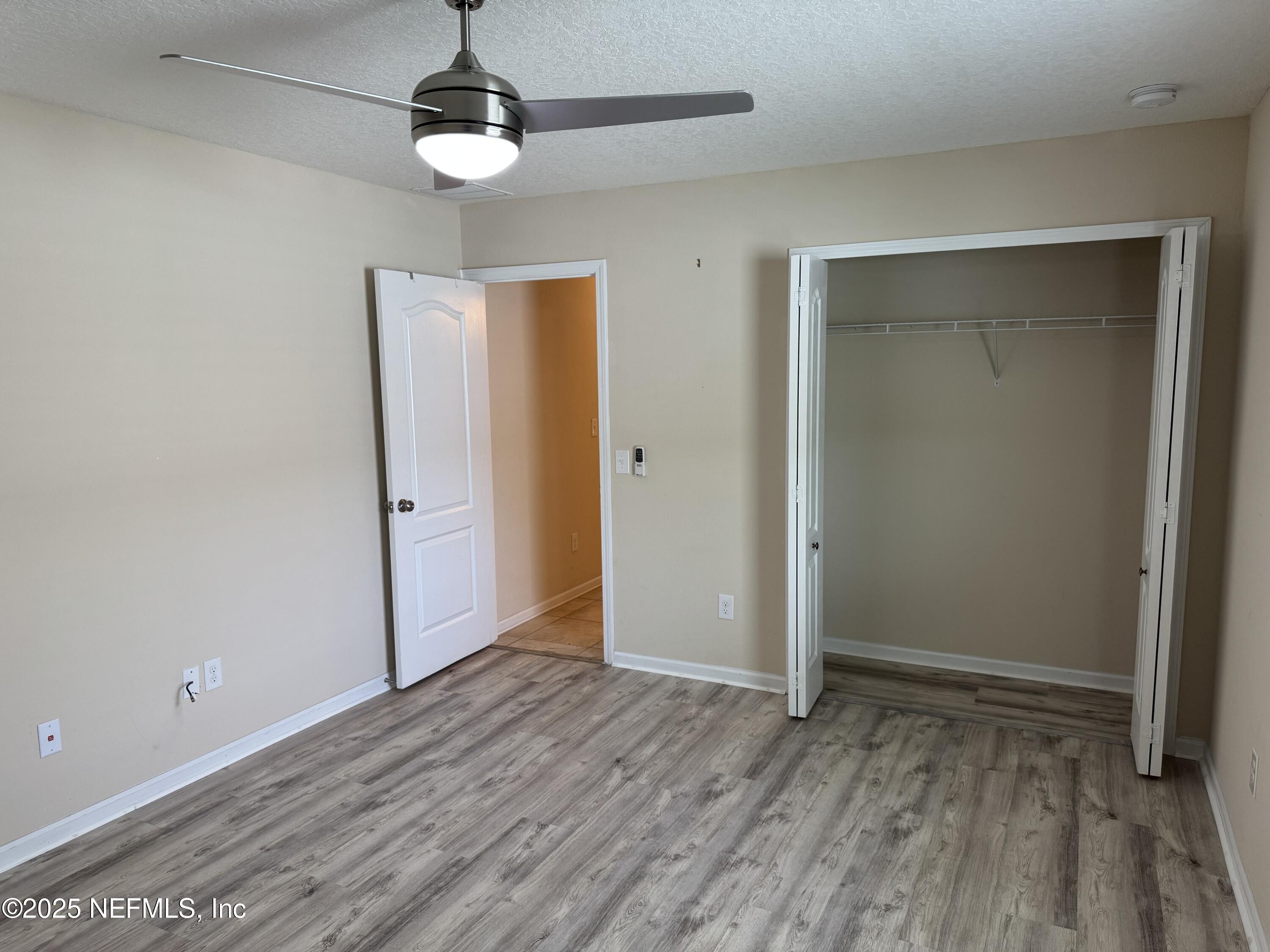96 Midway Park Drive St. Augustine, FL 32084 - Photo 21 of 31 wooden floor in an empty room with a window