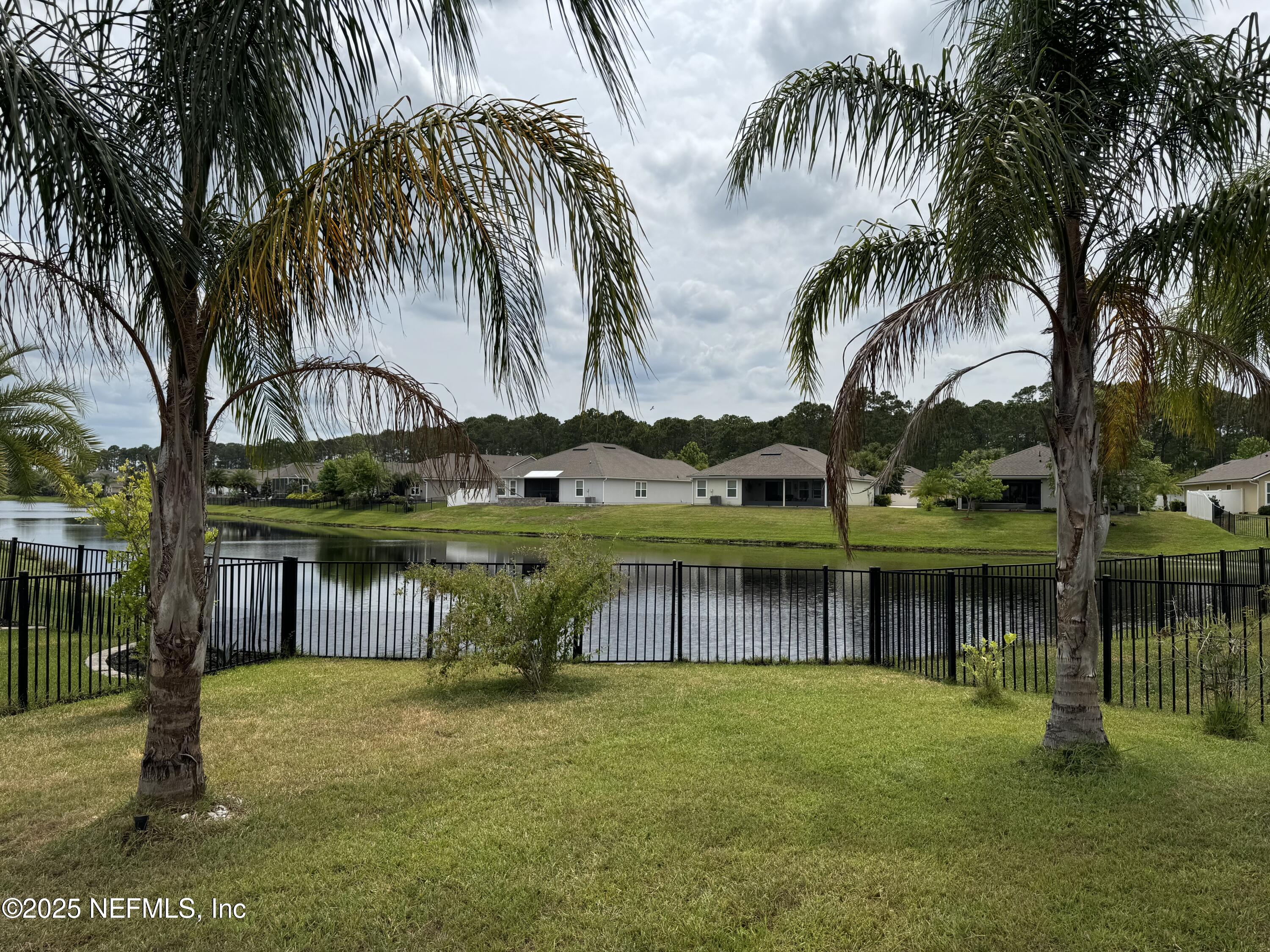 96 Midway Park Drive St. Augustine, FL 32084 - Photo 25 of 31 a backyard of a house with table and chairs