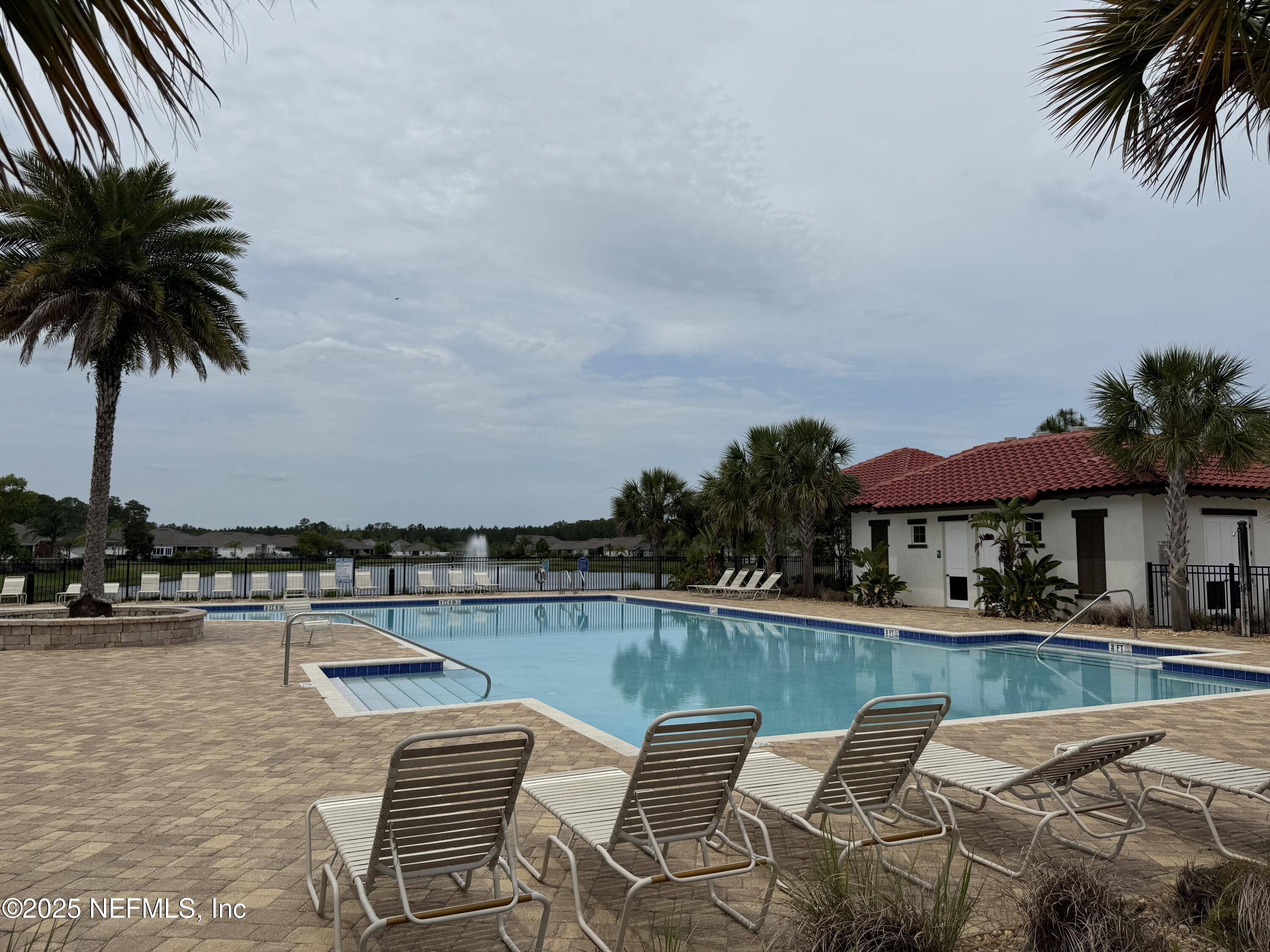 96 Midway Park Drive St. Augustine, FL 32084 - Photo 28 of 31 a view of a swimming pool and chairs in patio