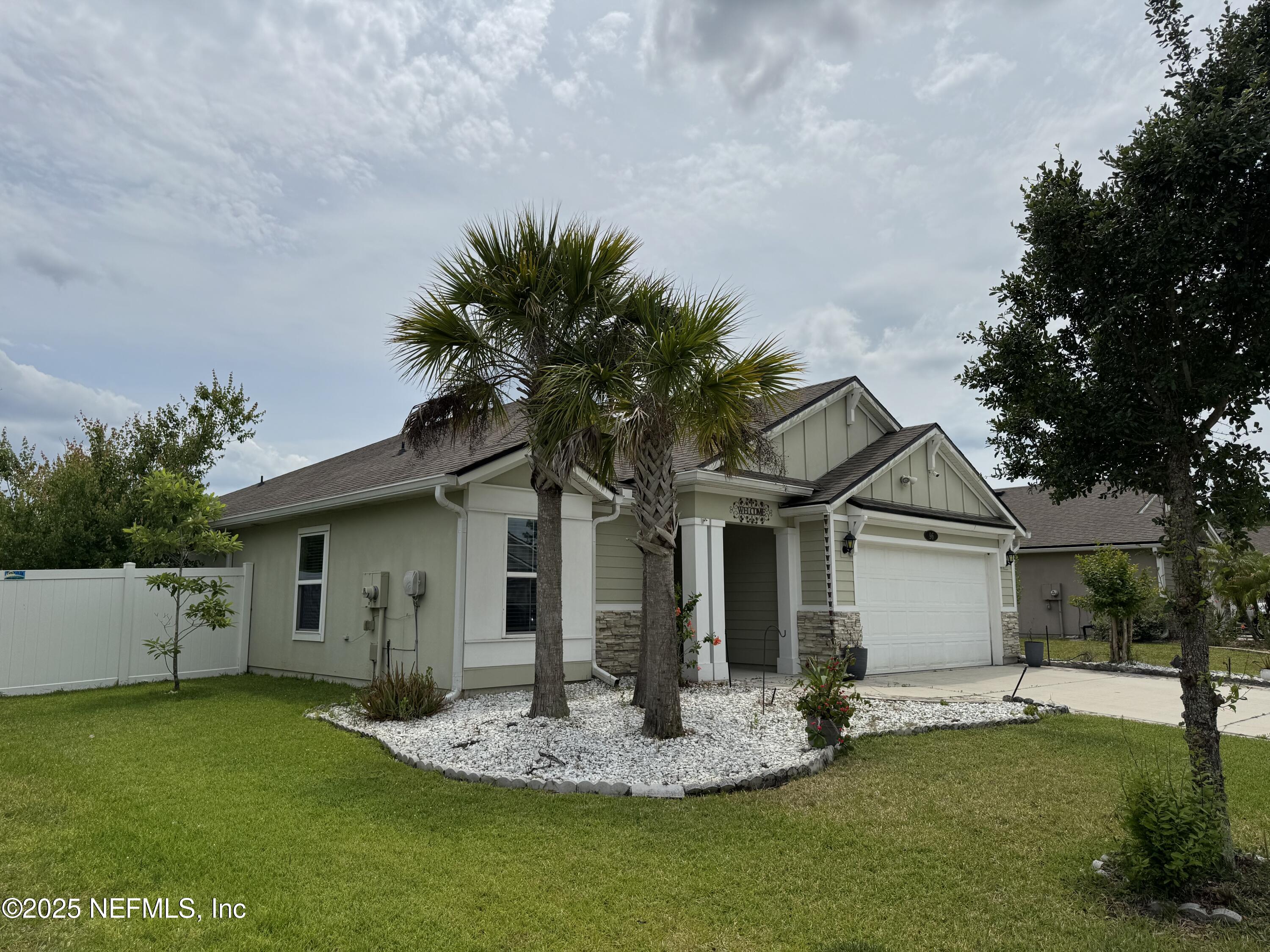 96 Midway Park Drive St. Augustine, FL 32084 - Photo 3 of 31 a front view of house with a garden and trees
