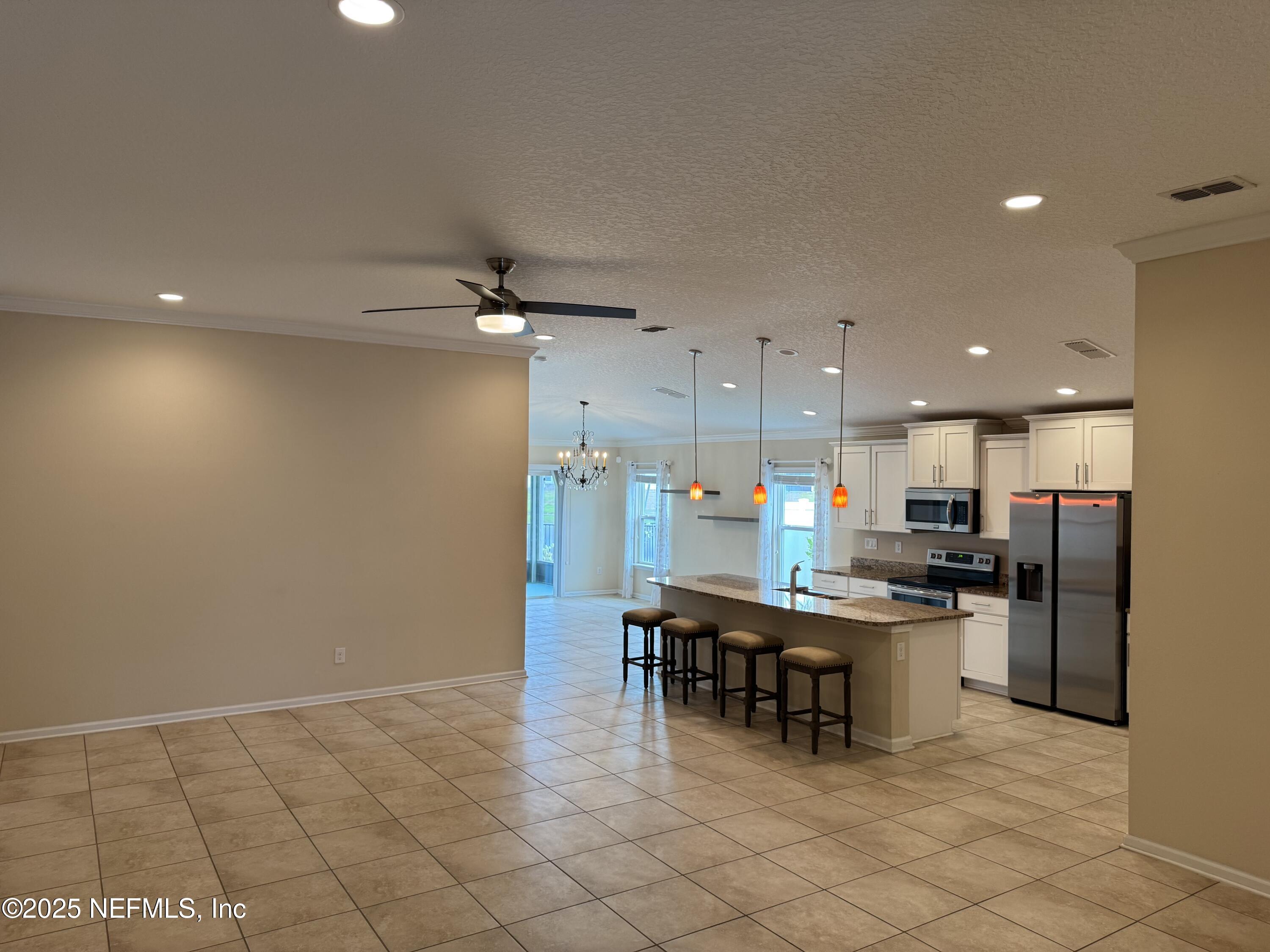 96 Midway Park Drive St. Augustine, FL 32084 - Photo 4 of 31 a kitchen with a table and chairs in it