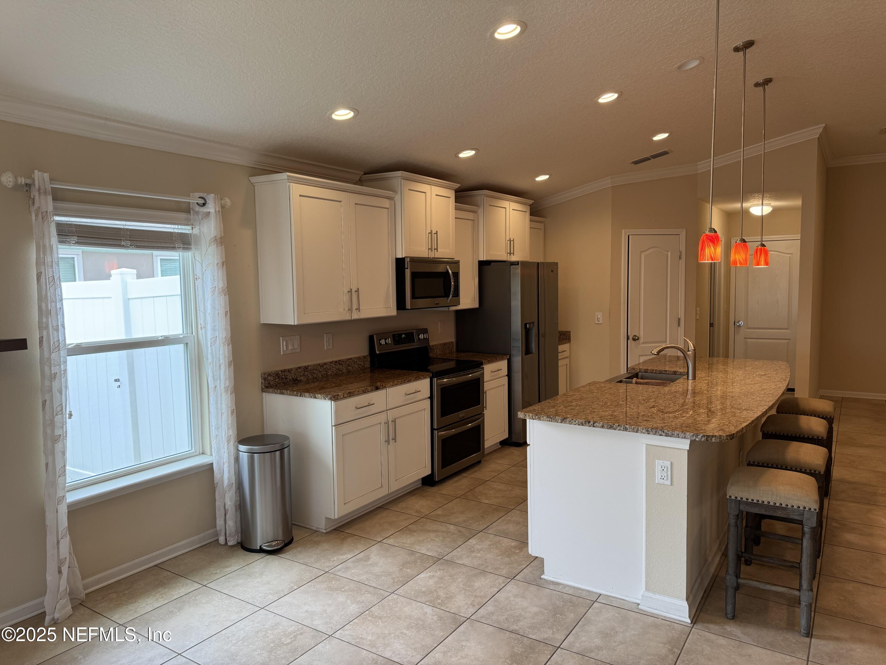 96 Midway Park Drive St. Augustine, FL 32084 - Photo 6 of 31 a kitchen with a sink cabinets and wooden floor