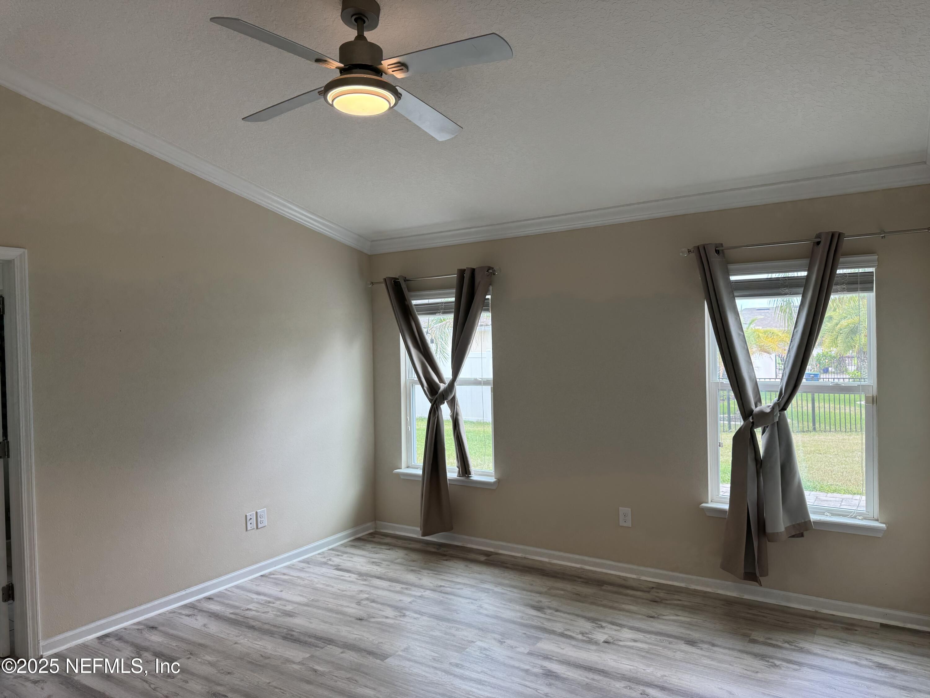 96 Midway Park Drive St. Augustine, FL 32084 - Photo 10 of 31 wooden floor in an empty room with a window