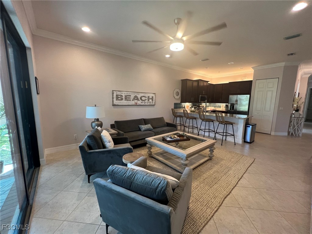 12016 Five Waters Circle Fort Myers, FL 33913 - Photo 7 of 19 a living room with furniture and a flat screen tv