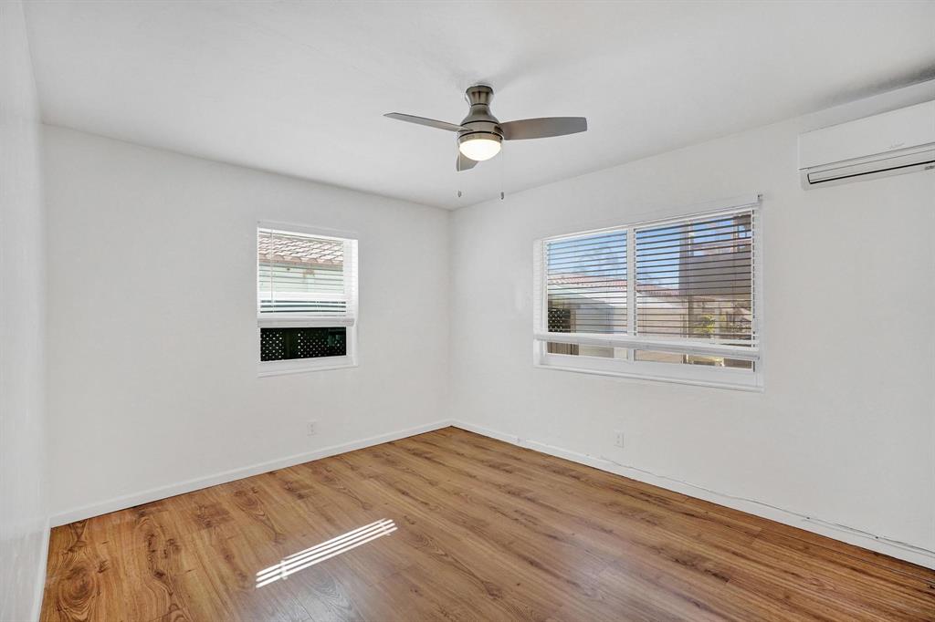 326 Madison Street, Unit 2 Hollywood, FL 33019 - Photo 14 of 27 a view of an empty room with wooden floor and a window