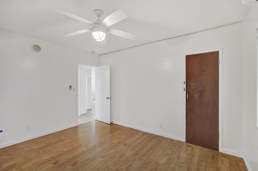 326 Madison Street, Unit 2 Hollywood, FL 33019 - Photo 19 of 27 an empty room with wooden floor and ceiling fan