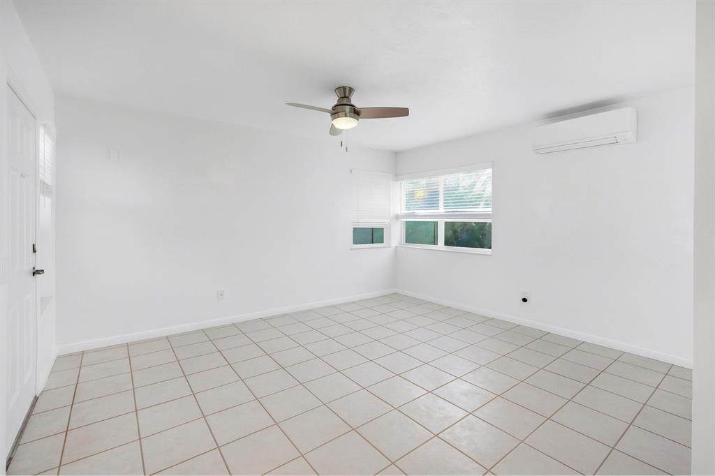 326 Madison Street, Unit 2 Hollywood, FL 33019 - Photo 4 of 27 an empty room with windows and fan
