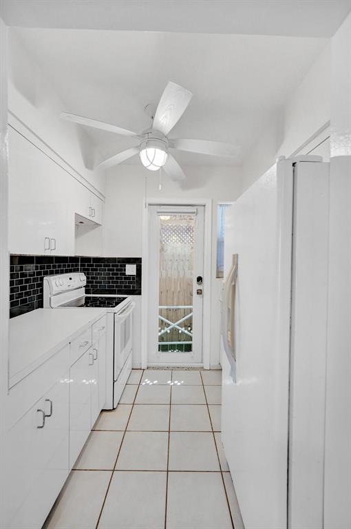 326 Madison Street, Unit 2 Hollywood, FL 33019 - Photo 7 of 27 a kitchen with white cabinets and white appliances