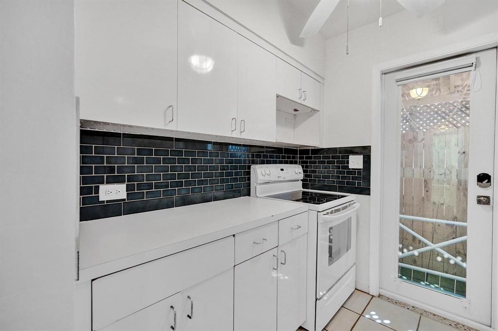 326 Madison Street, Unit 2 Hollywood, FL 33019 - Photo 8 of 27 a kitchen with white cabinets and sink