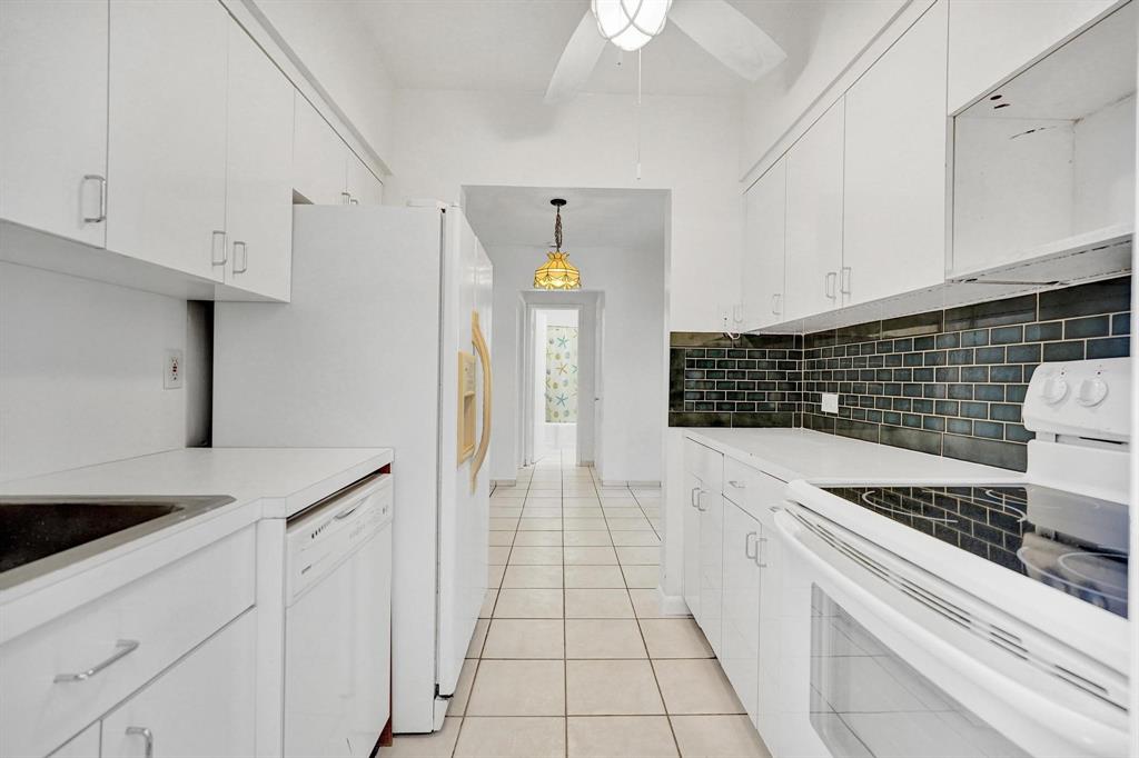 326 Madison Street, Unit 2 Hollywood, FL 33019 - Photo 9 of 27 a kitchen with white cabinets and appliances
