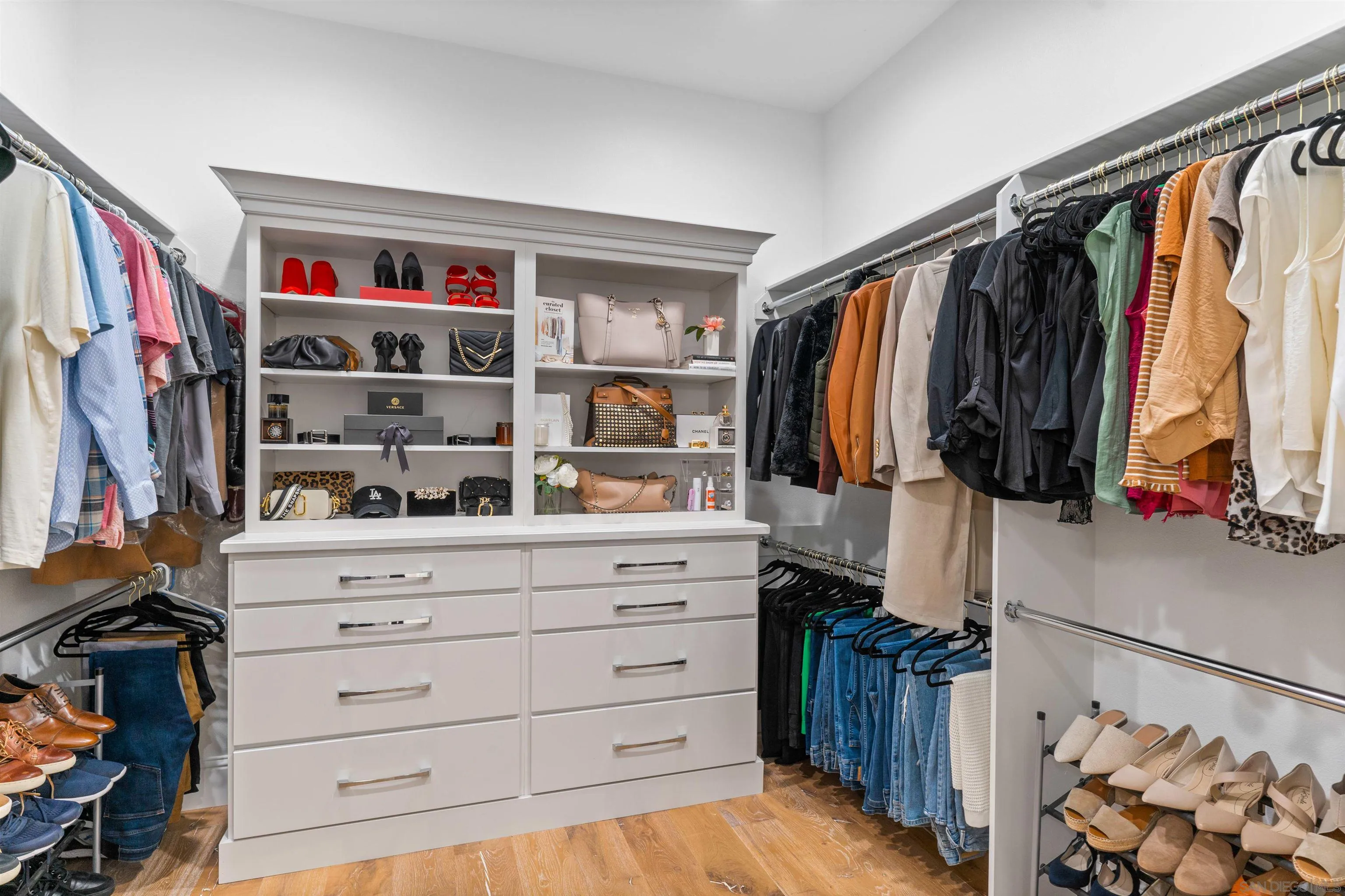 2520 Wellspring Street Carlsbad, CA 92010 - Photo 12 of 26 a view of walk in closet with clothes and shoes