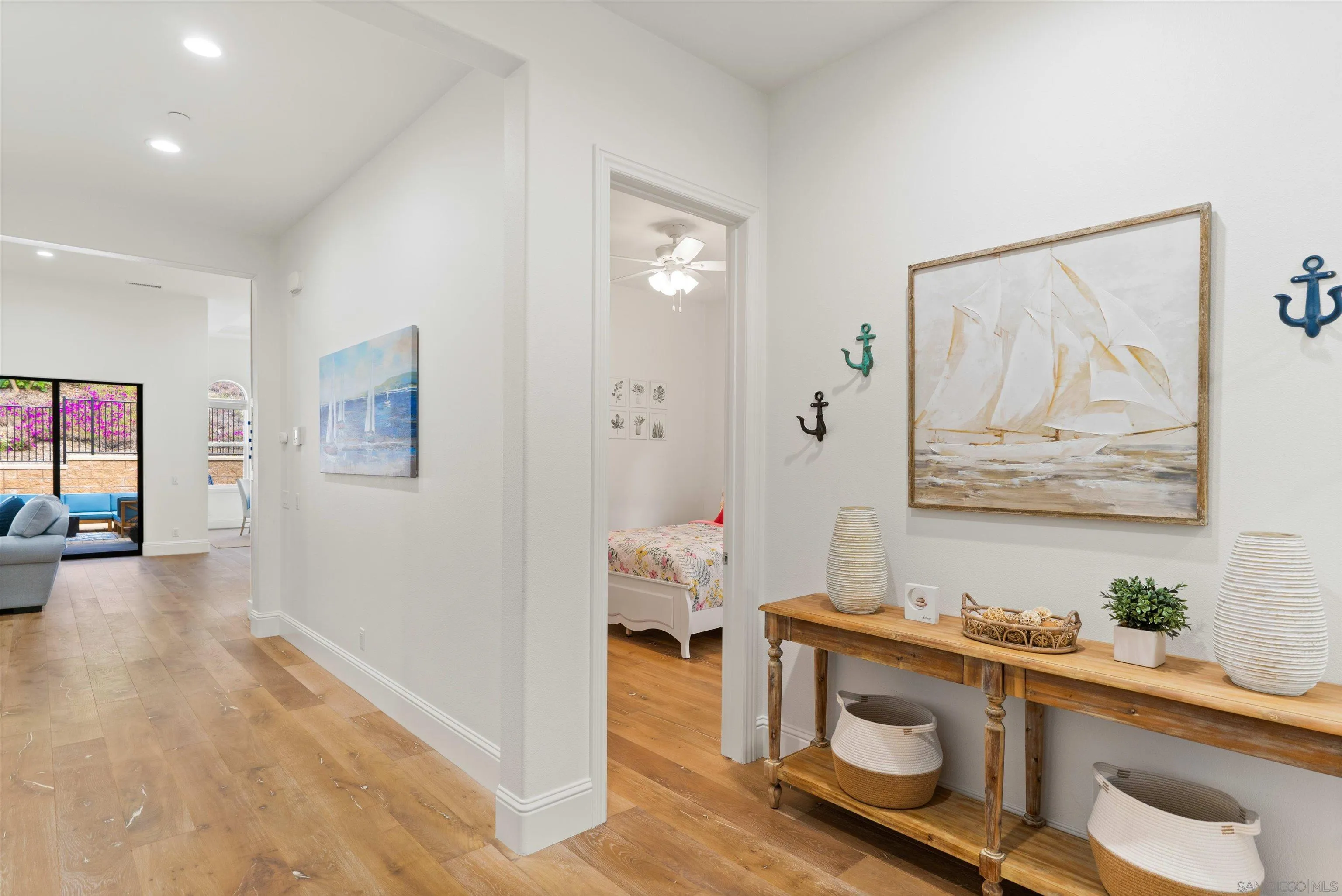 2520 Wellspring Street Carlsbad, CA 92010 - Photo 17 of 26 a hallway with a wooden floor and furniture