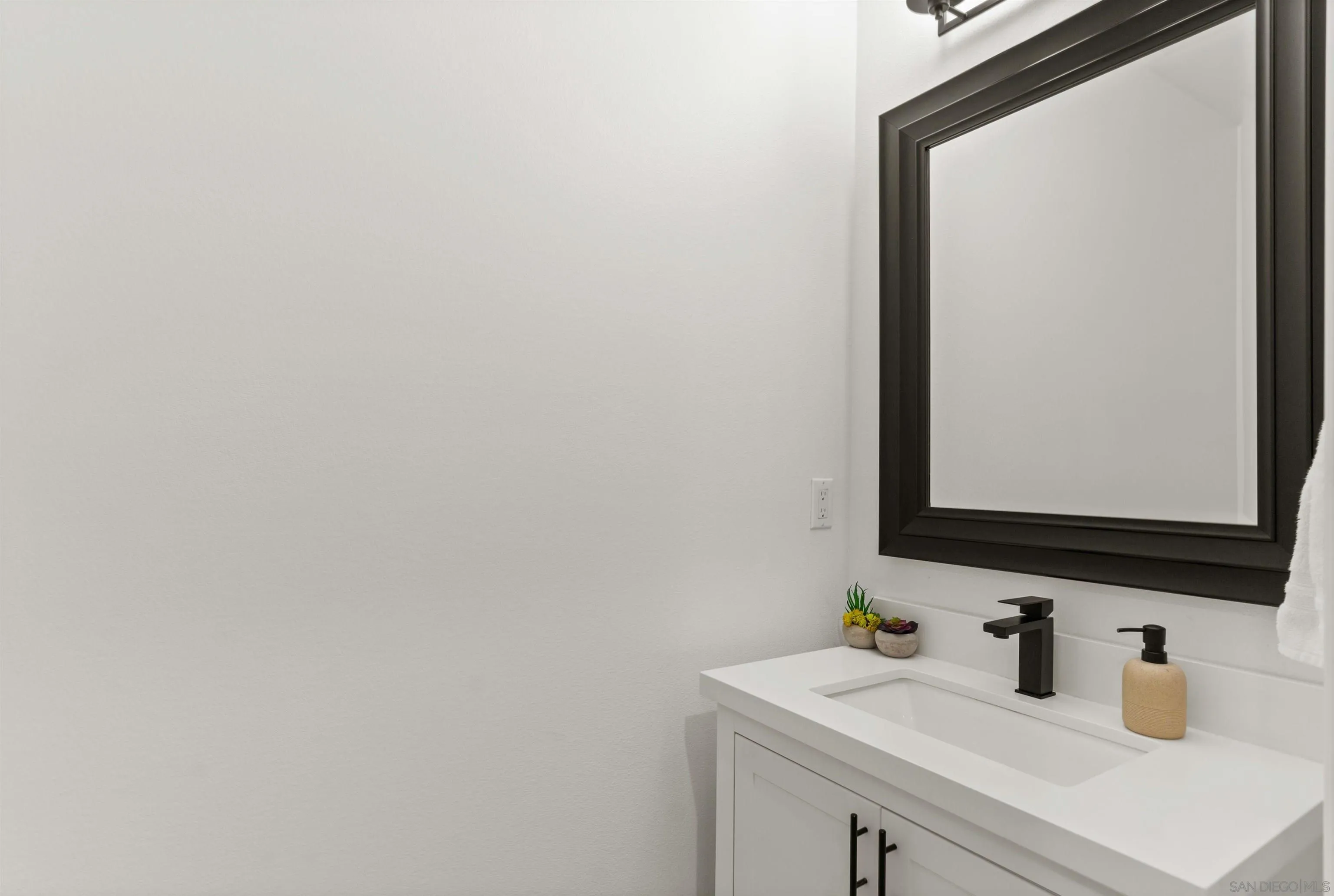 2520 Wellspring Street Carlsbad, CA 92010 - Photo 18 of 26 a bathroom with a sink and a mirror