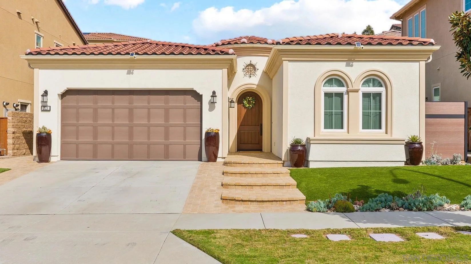 2520 Wellspring Street Carlsbad, CA 92010 - Photo 19 of 26 a front view of a house with a garden