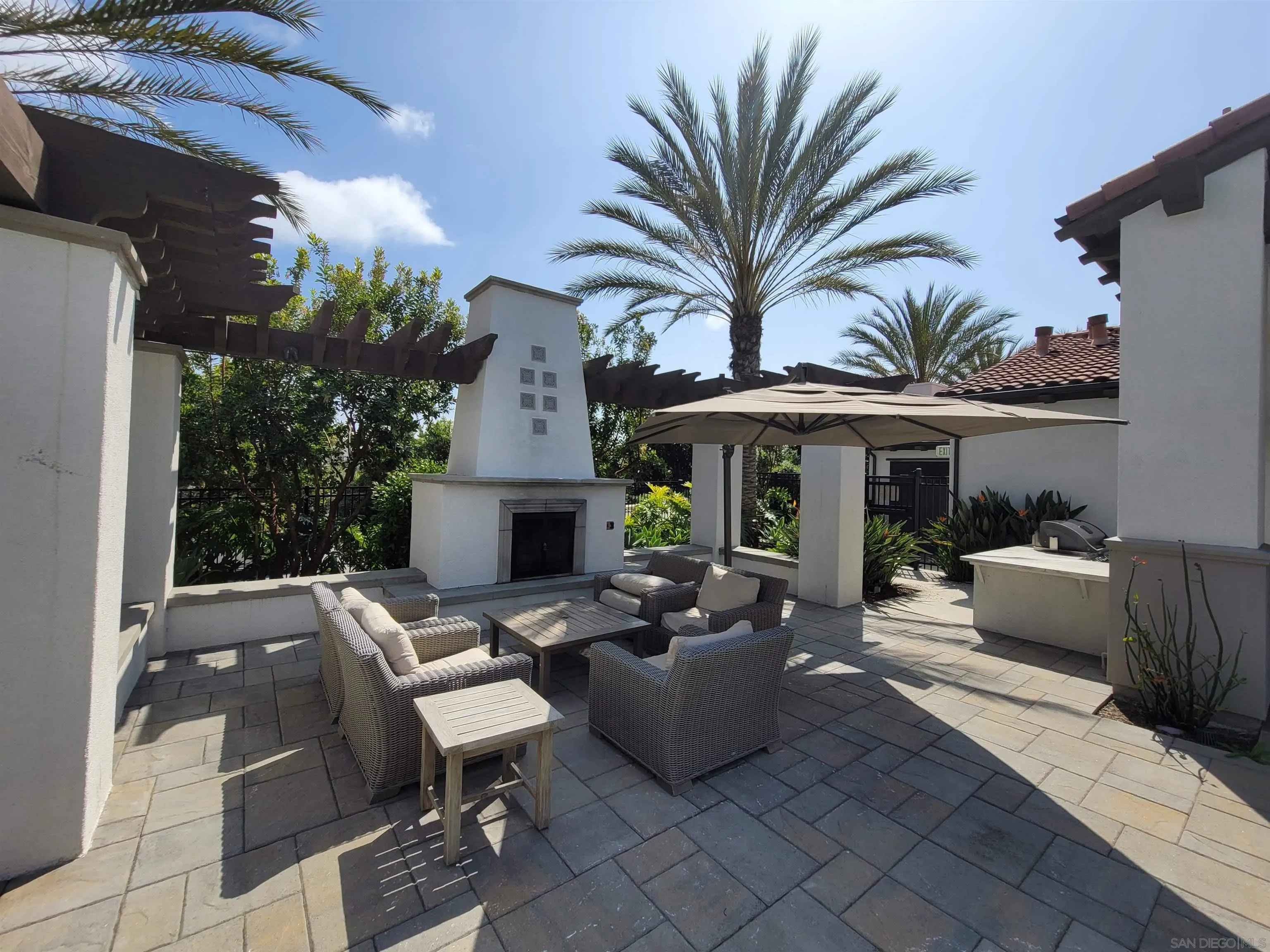 2520 Wellspring Street Carlsbad, CA 92010 - Photo 26 of 26 a view of a patio with table and chairs potted plants and palm tree