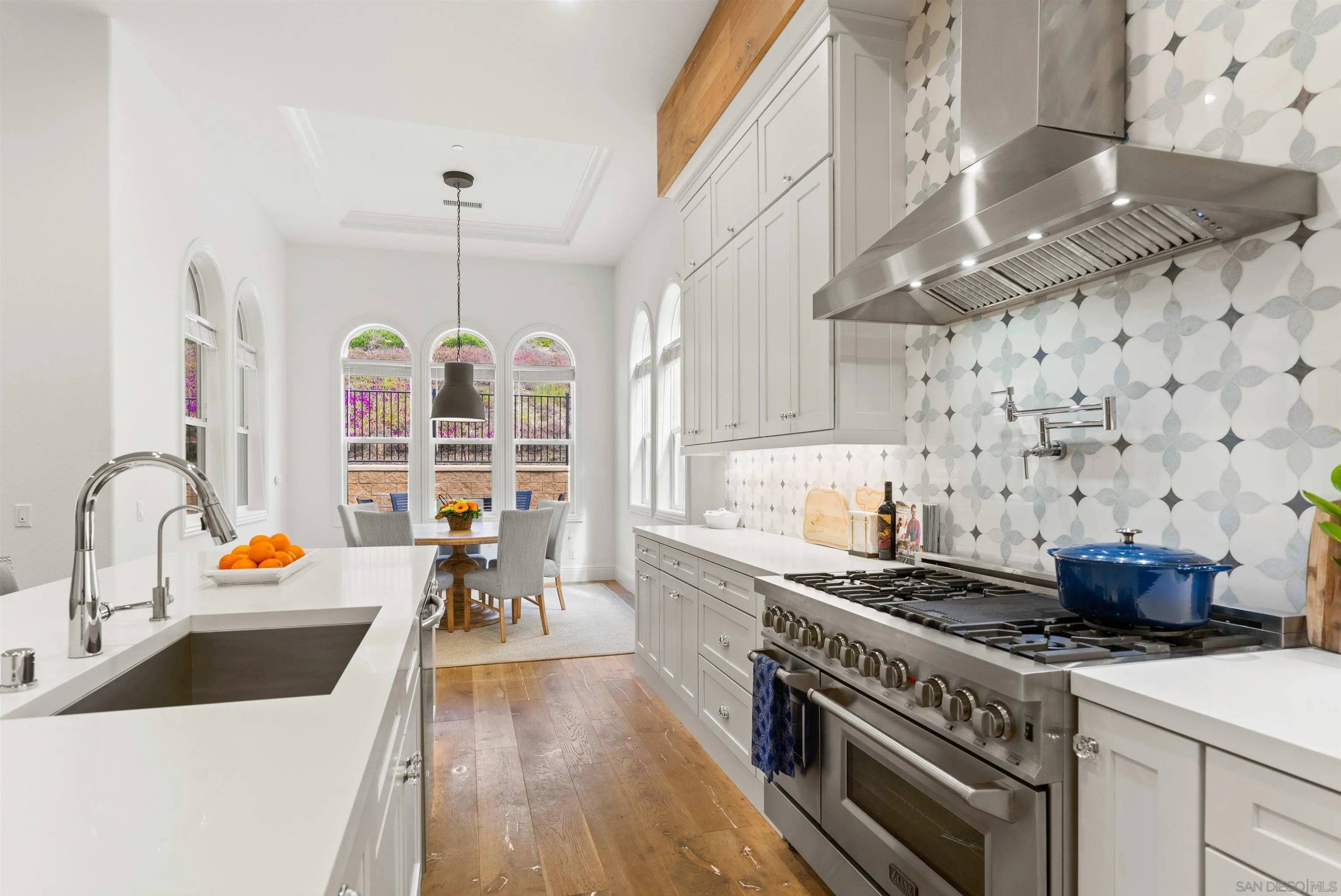 2520 Wellspring Street Carlsbad, CA 92010 - Photo 3 of 26 a kitchen with a stove and wooden floor