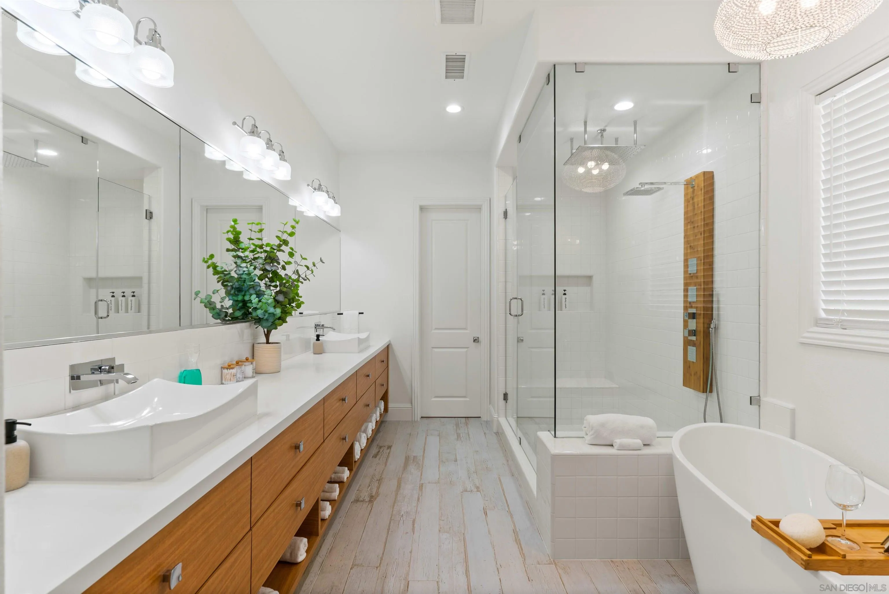 2520 Wellspring Street Carlsbad, CA 92010 - Photo 5 of 26 a bathroom with a granite countertop sink a large mirror a bathtub and shower