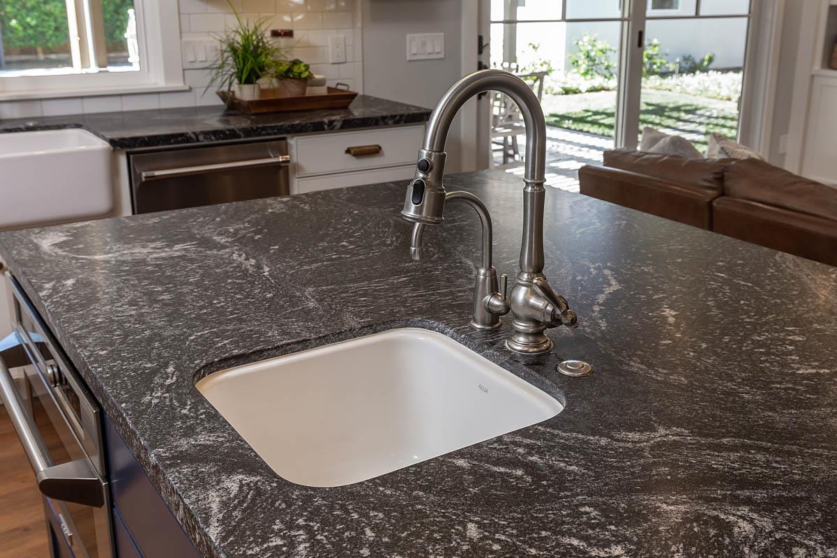 1489 Brookmill Road Los Altos, CA 94024 - Photo 11 of 43 a bathroom with a granite countertop sink a large mirror and a window
