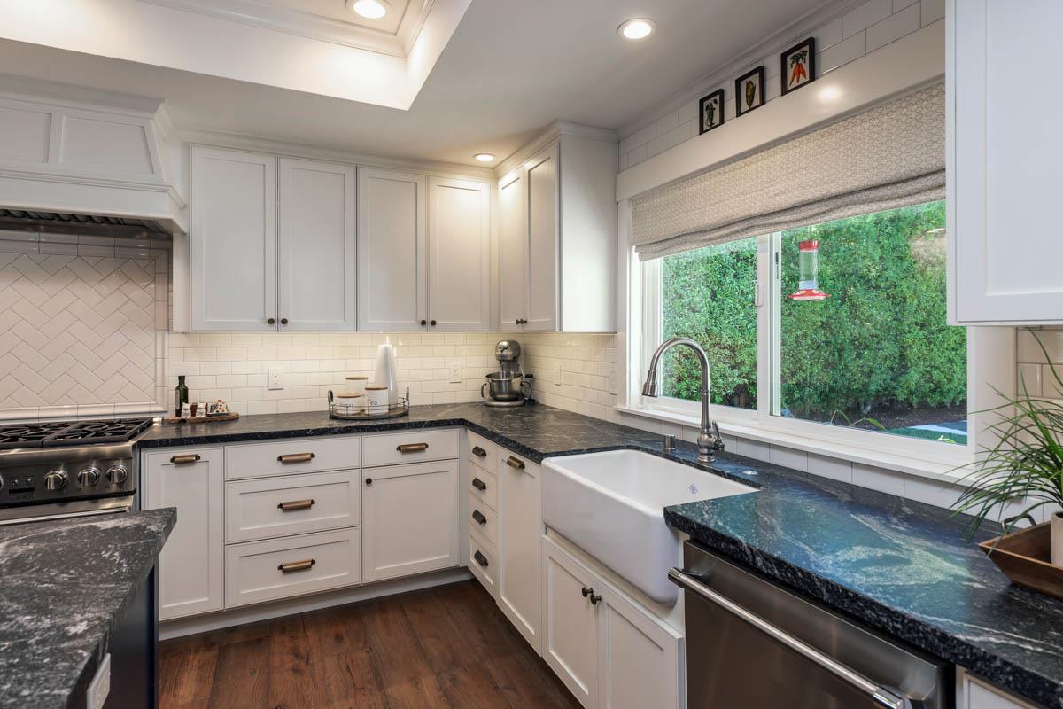 1489 Brookmill Road Los Altos, CA 94024 - Photo 12 of 43 a kitchen with granite countertop white cabinets white appliances a sink and a large window