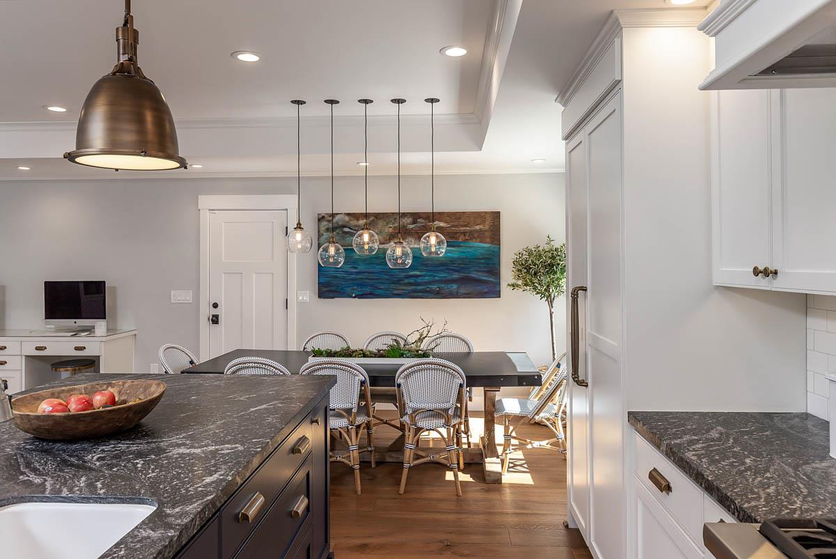 1489 Brookmill Road Los Altos, CA 94024 - Photo 13 of 43 a kitchen with stainless steel appliances granite countertop a stove top oven a sink a dining table and chairs with wooden floor