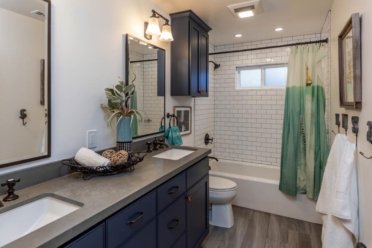 1489 Brookmill Road Los Altos, CA 94024 - Photo 19 of 43 a bathroom with a granite countertop sink a toilet and shower