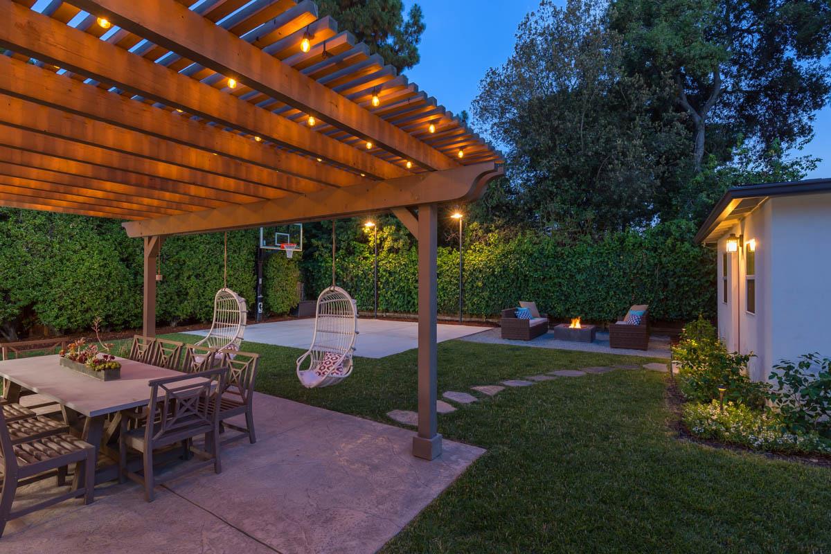 1489 Brookmill Road Los Altos, CA 94024 - Photo 29 of 43 a view of a patio with a table and chairs under a large umbrella