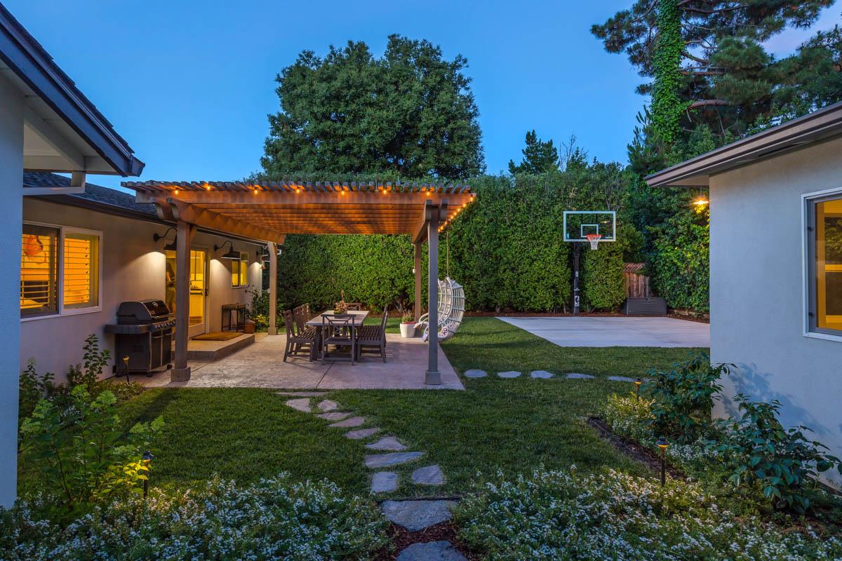 1489 Brookmill Road Los Altos, CA 94024 - Photo 30 of 43 a view of a backyard with table and chairs potted plants and a large tree