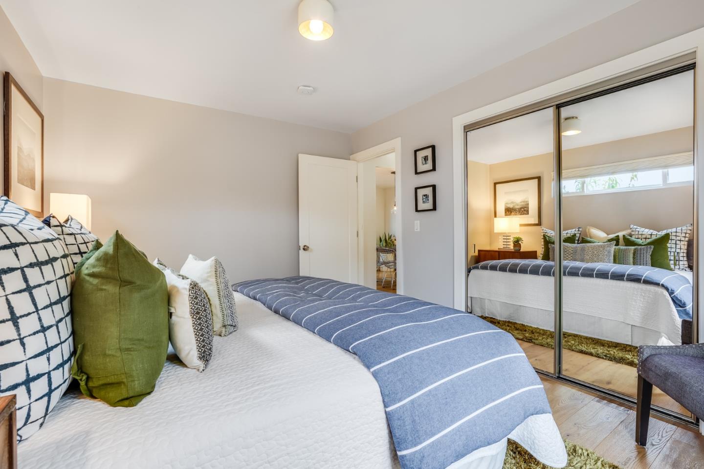 646 Brighton Road Pacifica, CA 94044 - Photo 11 of 26 a bedroom with a bed and a mirror