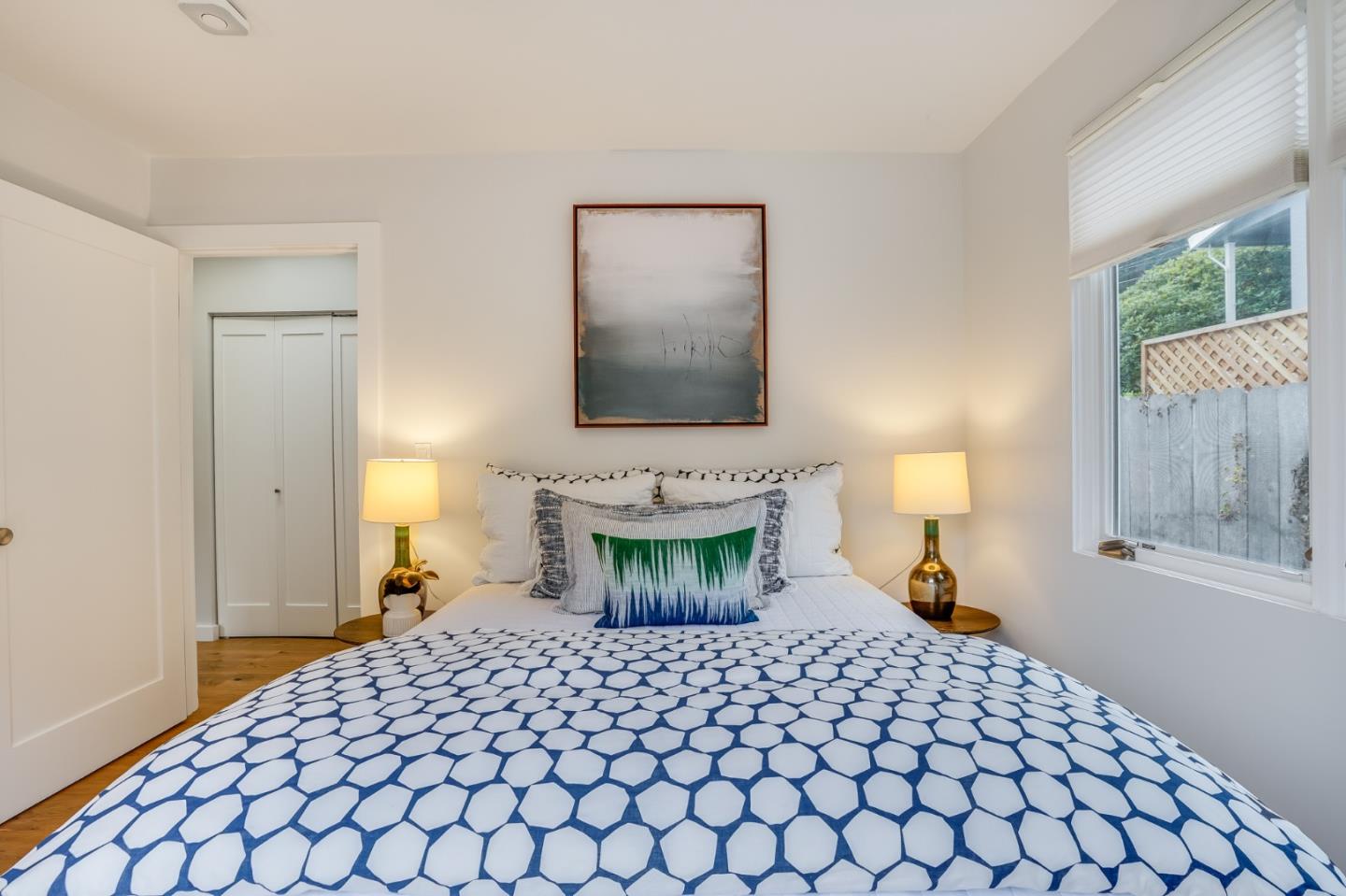 646 Brighton Road Pacifica, CA 94044 - Photo 16 of 26 a bedroom with a bed and a lamp