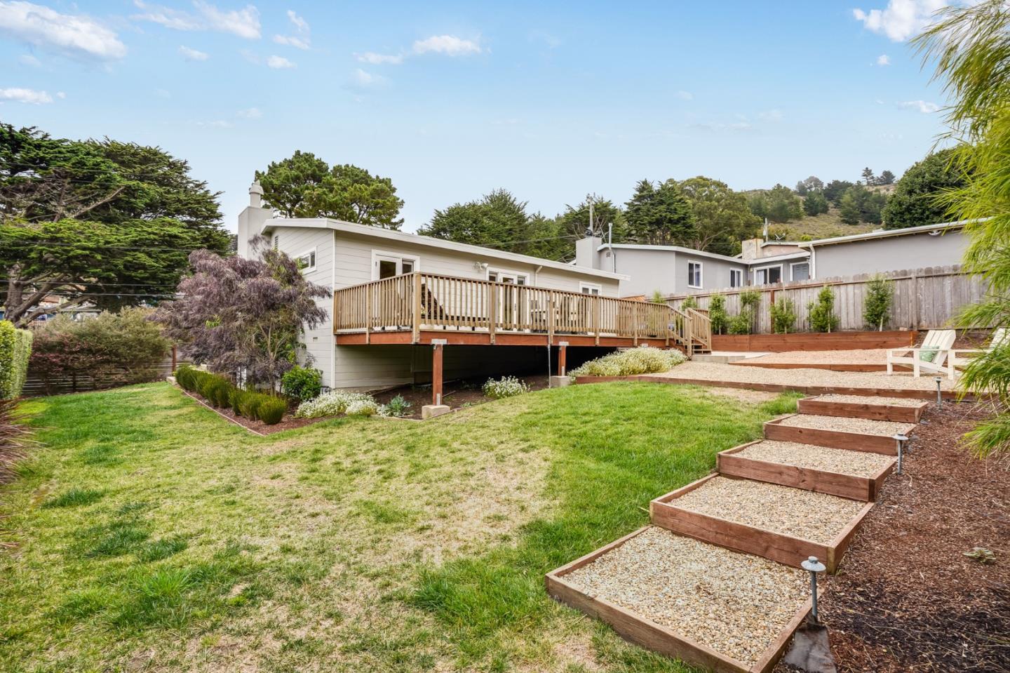 646 Brighton Road Pacifica, CA 94044 - Photo 20 of 26 a view of a house with a backyard and a patio