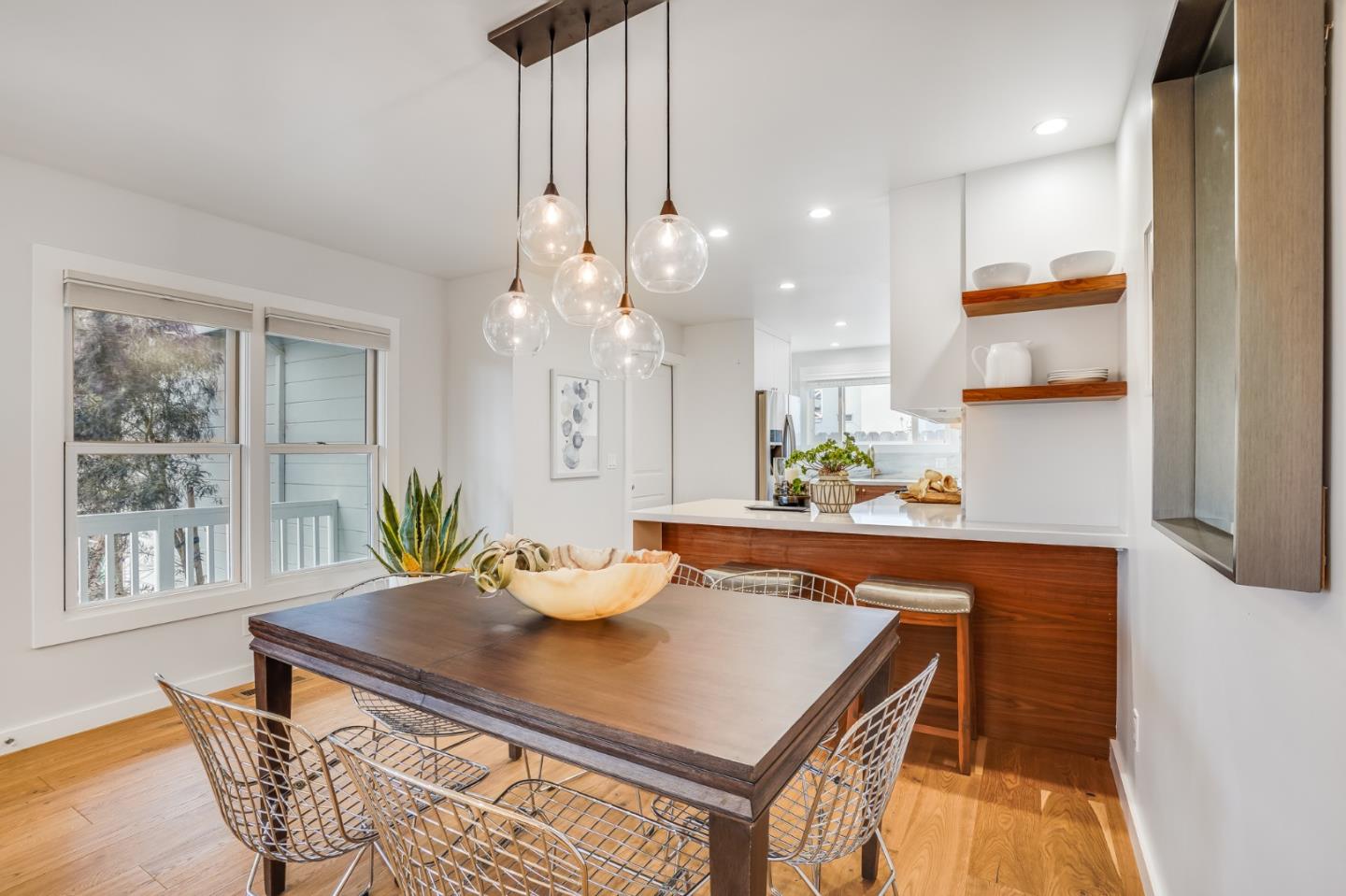 646 Brighton Road Pacifica, CA 94044 - Photo 6 of 26 a room with stainless steel appliances a table and chairs in it