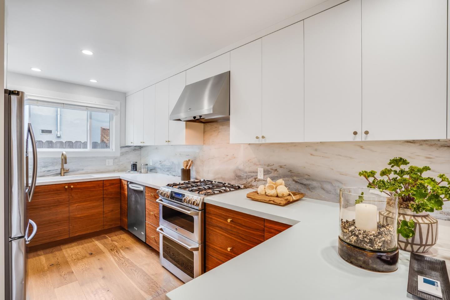 646 Brighton Road Pacifica, CA 94044 - Photo 7 of 26 a kitchen with stainless steel appliances granite countertop a sink stove and cabinets