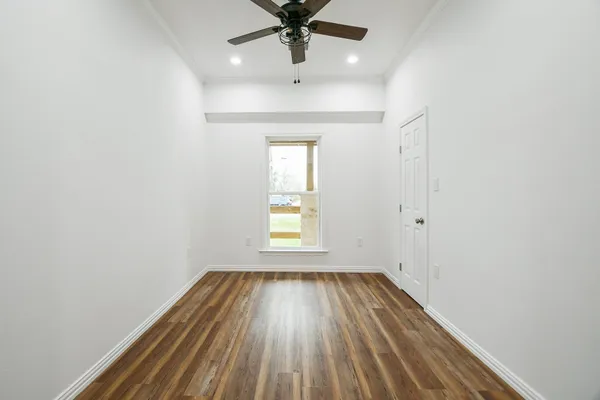 wooden floor in an empty room with a window