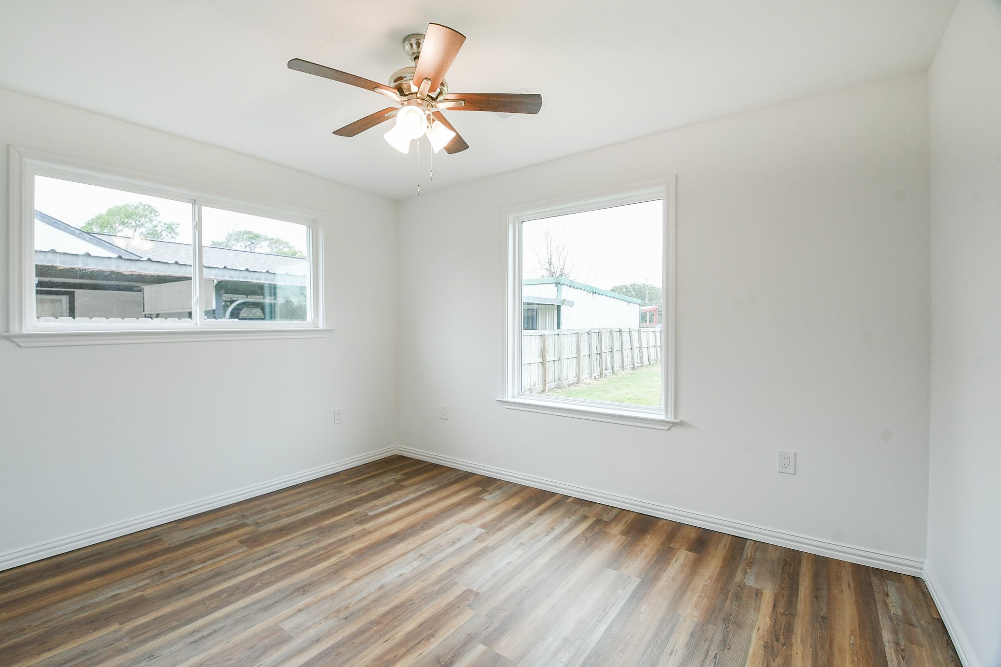 3200 Hoover Street La Marque, TX 77568 - Photo 14 of 31 an empty room with wooden floor and windows