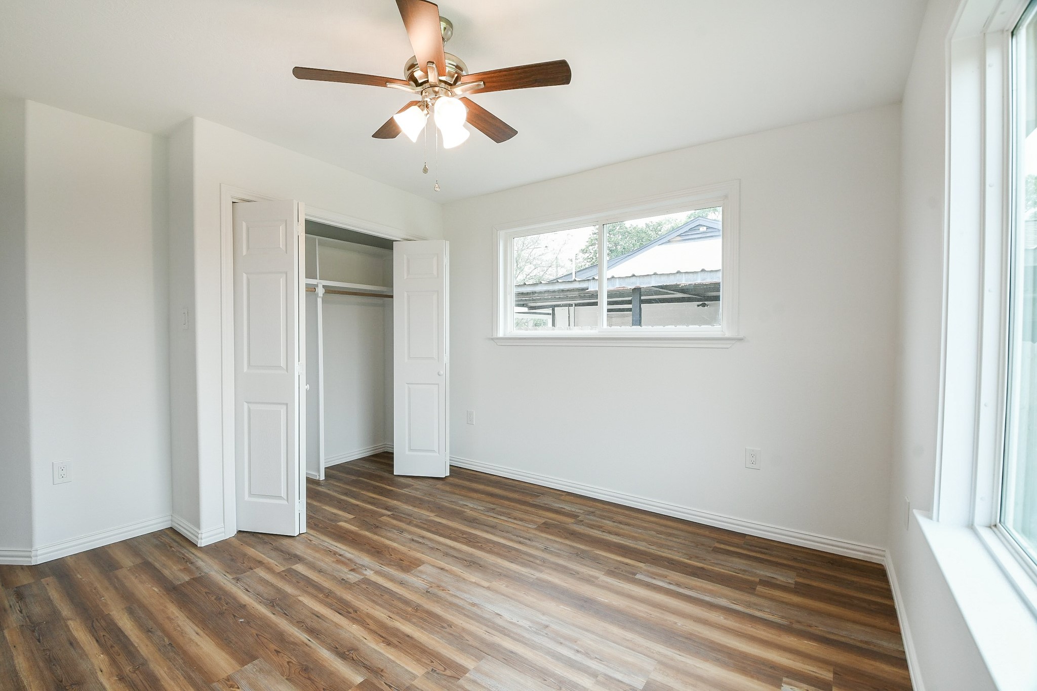 3200 Hoover Street La Marque, TX 77568 - Photo 15 of 31 a view of empty room with wooden floor and fan