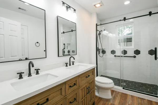 a bathroom with a sink toilet a mirror and shower