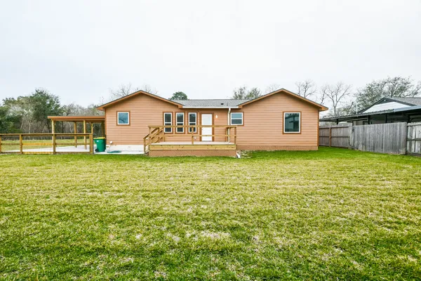 a view of a house with a yard and sitting area