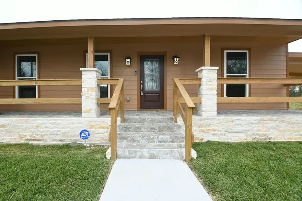 a front view of a house with garden